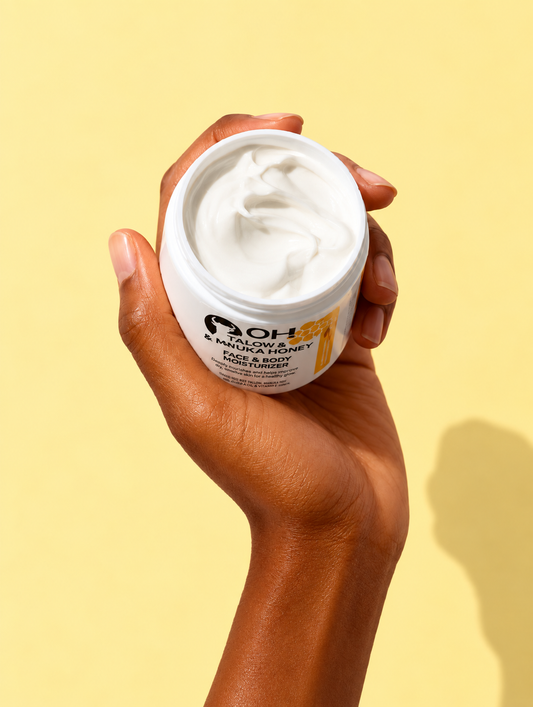Hand holding open jar of white face & body moisturizer